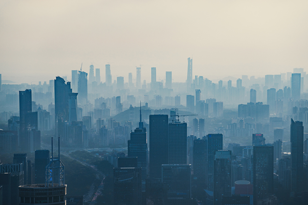 Buildings surrounded by smog in a polluted environment.